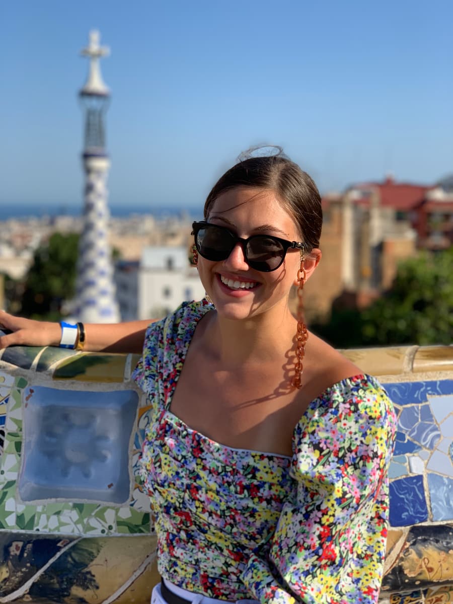 Juliana on the mosaic terrace of Gaudí’s Park Güell above the city