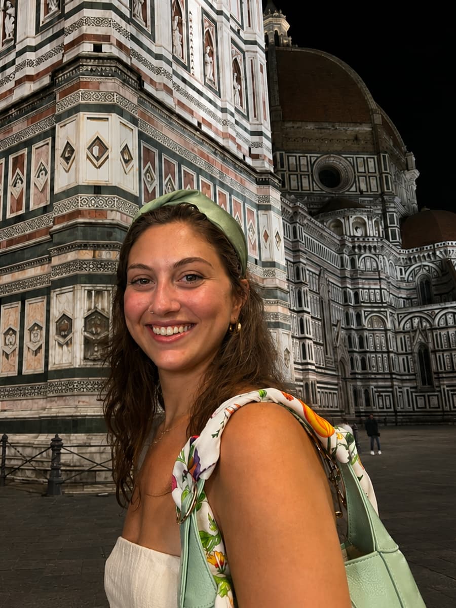 Juliana in front of the marble facade of the Florence Duomo