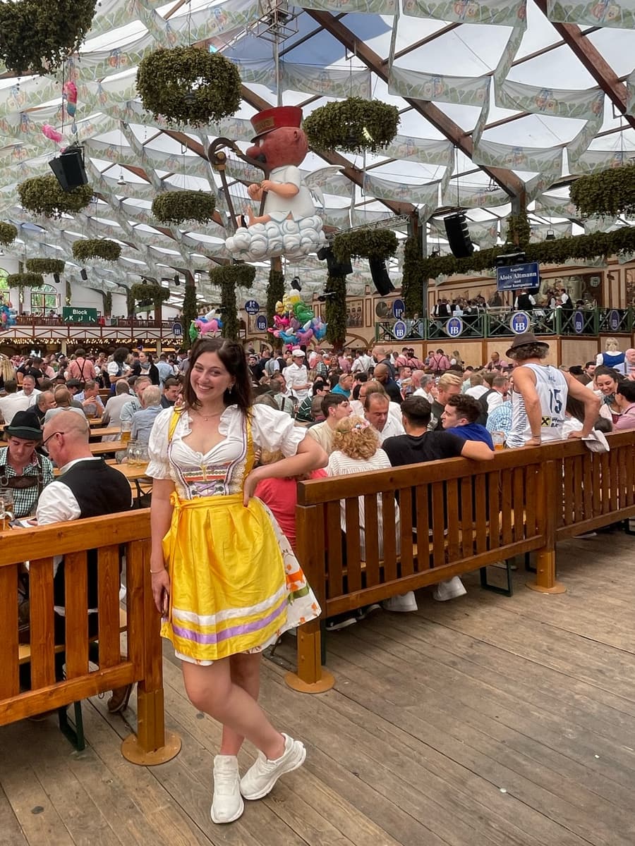 Juliana in a dirndl at a packed Oktoberfest beer hall