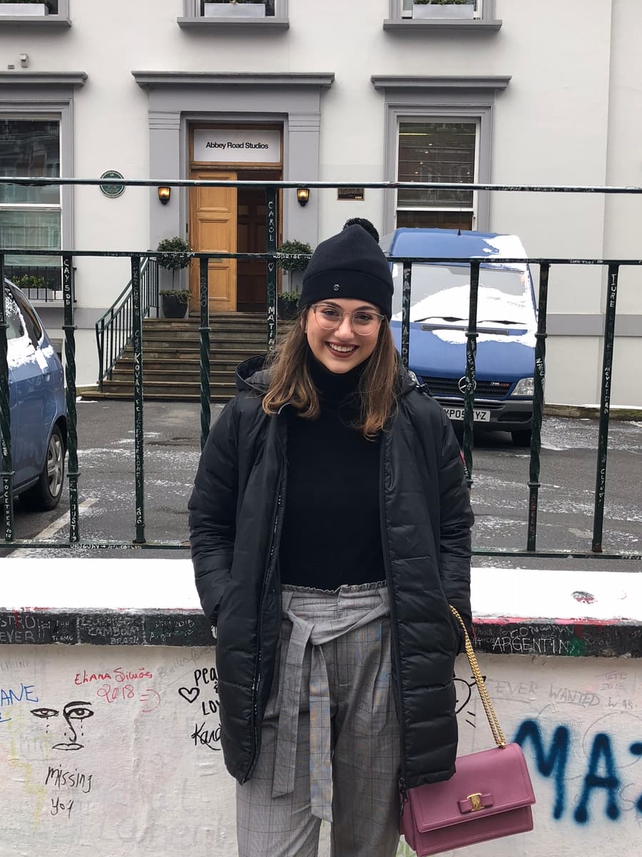 Juliana on a London street in front of a white townhouse