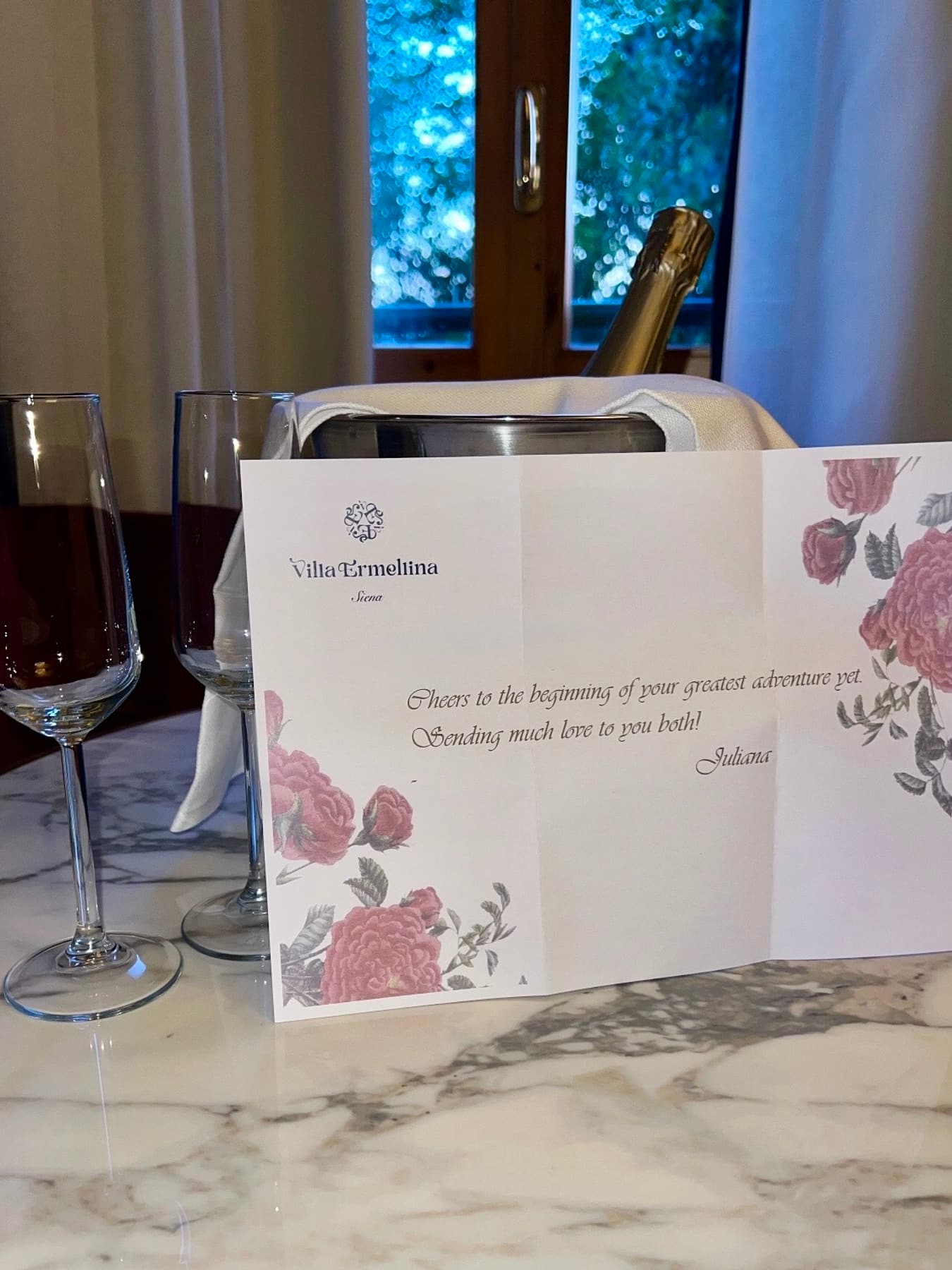 A handwritten welcome card and chilled champagne waiting in a villa